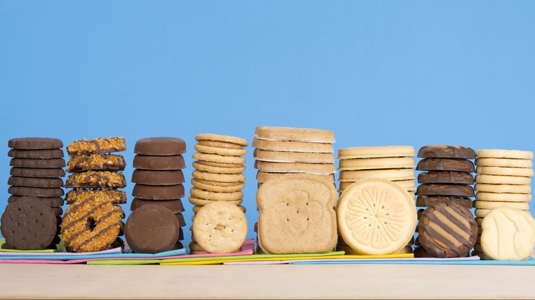 Various Girl Scout cookies stacked on table