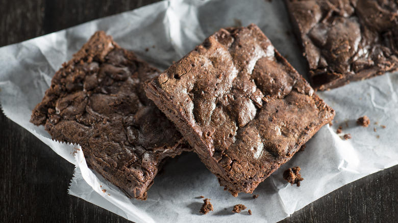 Brownies on parchment paper dark background