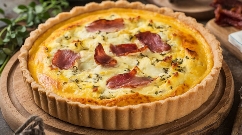 Quiche Lorraine on a round wooden serving platter