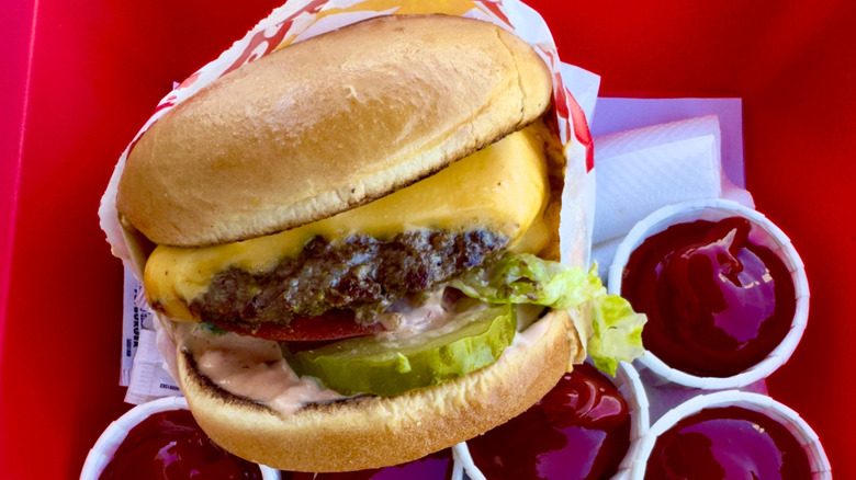 Double-double Animal Style burger at In-N-Out on red tray.