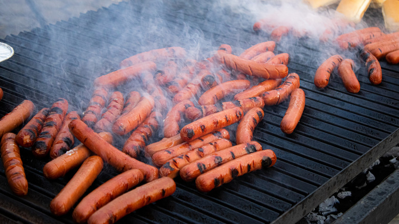 Too many hot dogs on a grill