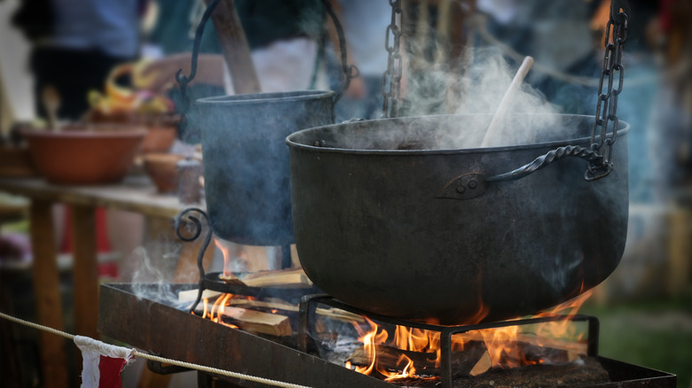 Cooking in an iron pot over wood fire