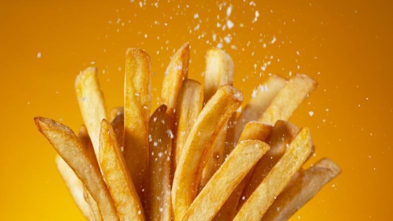 salt falling on french fries