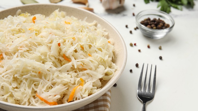 A dish of sauerkraut with peppercorns.