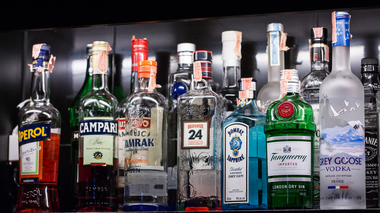 A shelf with a variety of alcohol bottles