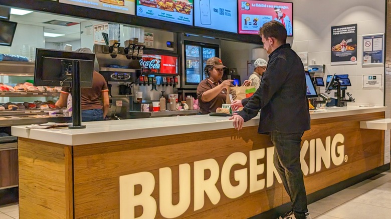 Customer ordering food at the counter at Burger King