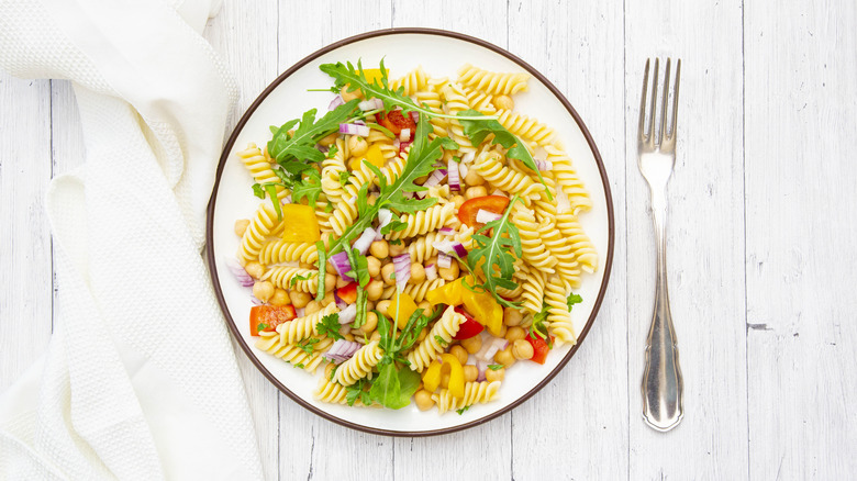 Plate of pasta salad on a wooden table