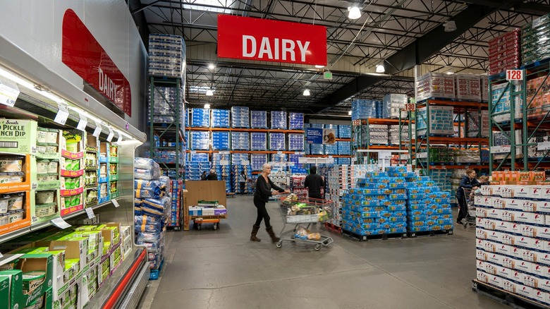 Costco shoppers in dairy section with carts