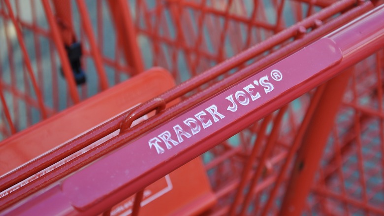 closeup of the Trader Joe's logo on a shopping cart handle