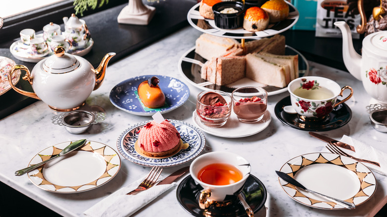 formal afternoon tea setting with pastries and china