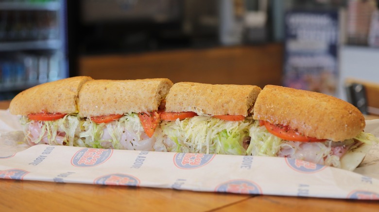 Jersey Mike's giant sub cut into four pieces on paper wrapping