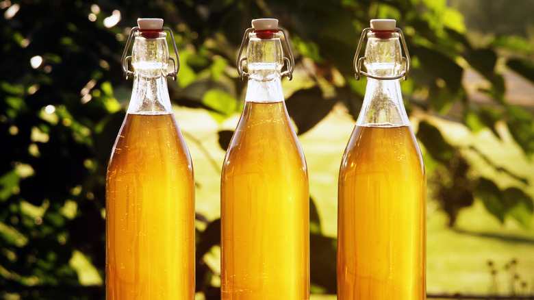 Three bottles of golden colored mead