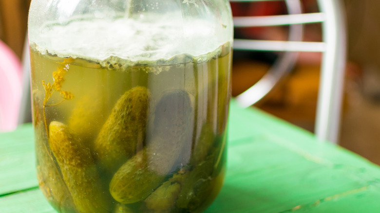 jar of pickles with mold on the surface
