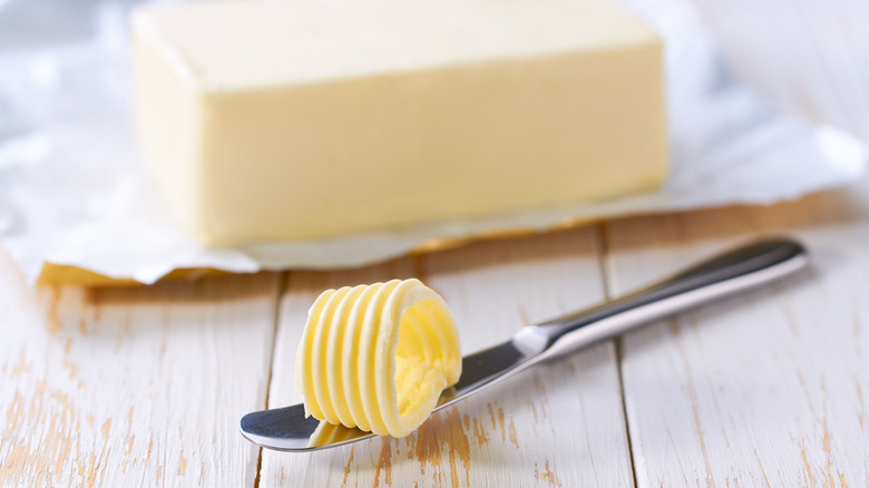 Butter on a knife and on a table