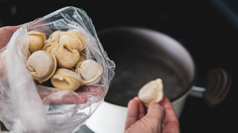 Frozen stuffed tortellini pasta being cooked in a skillet