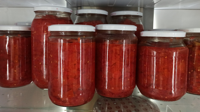 Jars of tomato sauce in the fridge