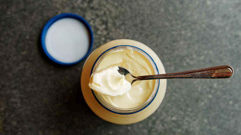opened jar of mayonnaise with a spoon resting on top
