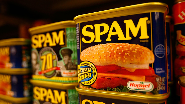 Cans of Spam on a store shelf.