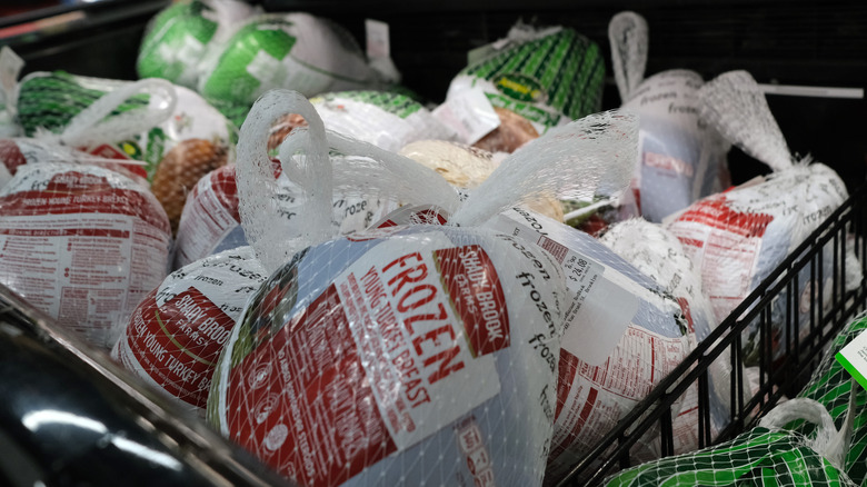 Frozen whole turkeys in a store freezer case