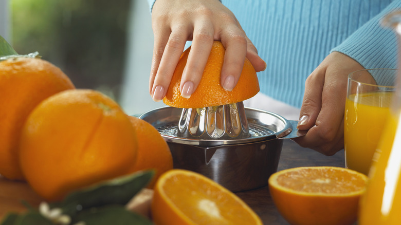 woman making fresh orange juice