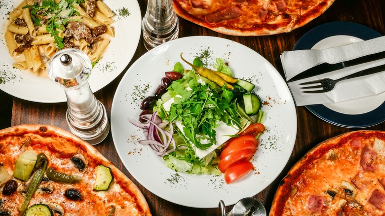 Pizzas with salad and pasta