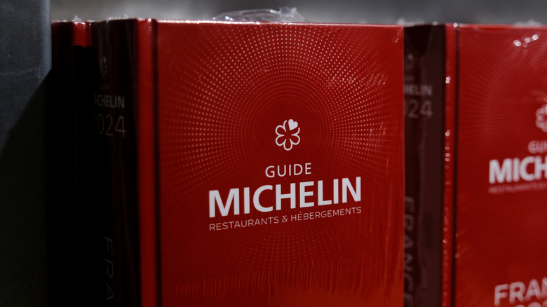 Stack of red Michelin guides in shop.