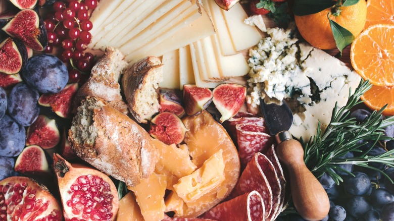 Charcuterie board with fruits, cheese, meat