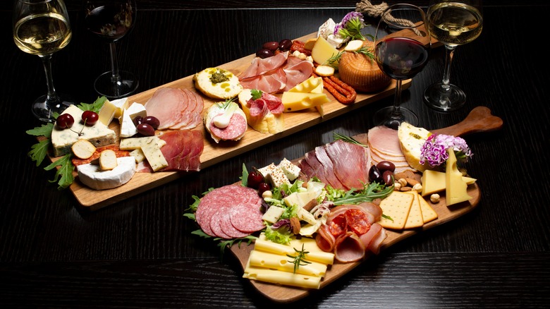 Two charcuterie boards with wine