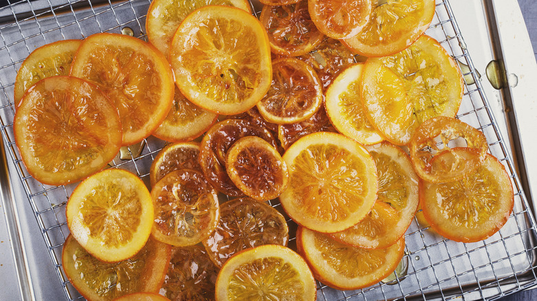 Candied orange and lemon slices on a wire rack.