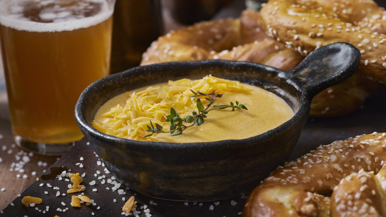 Beer cheese sauce with soft salted pretzels.