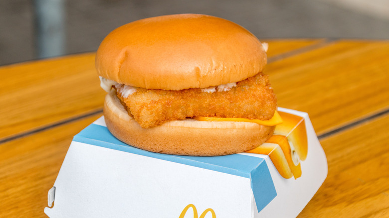 McDonald's Filet of Fish on top of a paper to-go box on a wooden table.