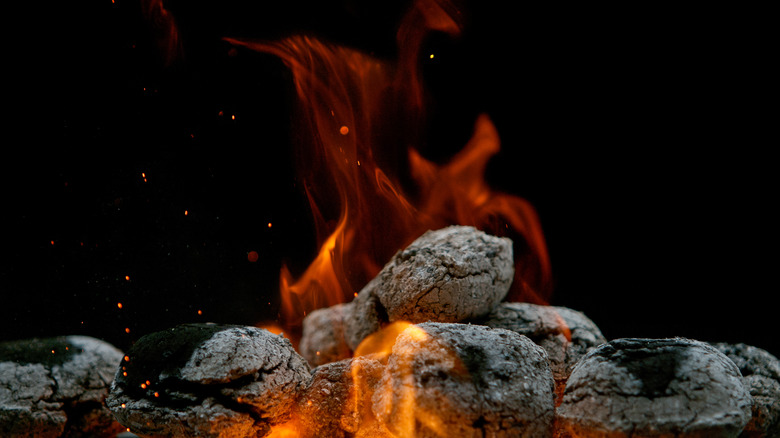 Flaming charcoal briquettes