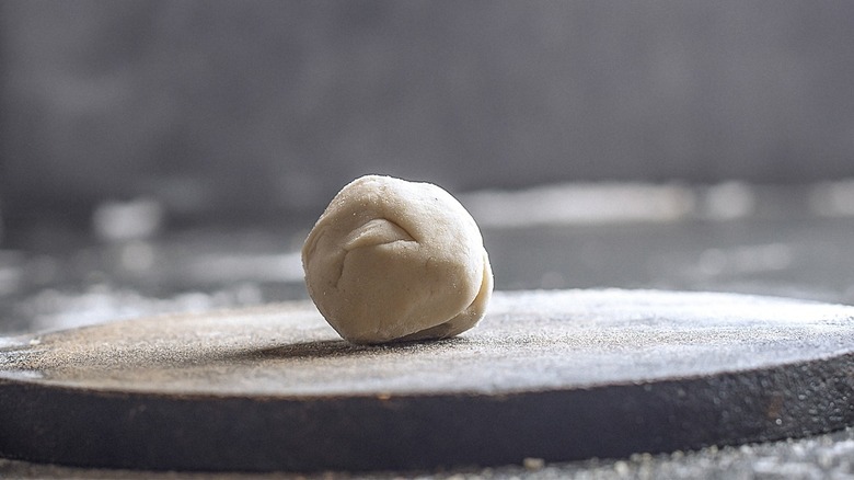 Ball of tortilla dough on level surface