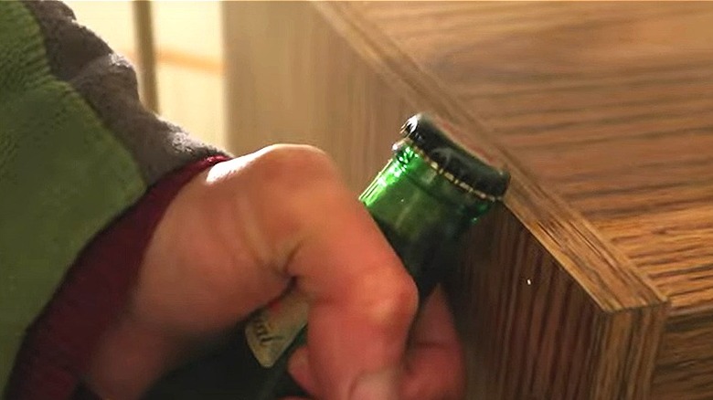 bottle cap opening on edge of table