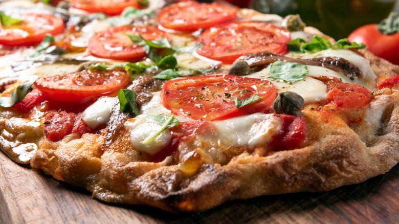 pizza with tomatoes and anchovies