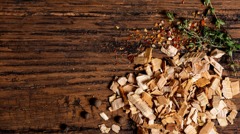 Wood chips with herbs and seasonings in wood table