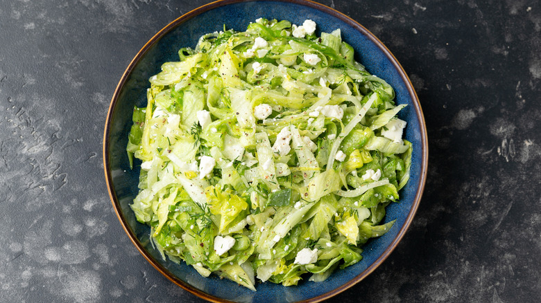 big bowl of chopped iceberg lettuce salad with feta cheese