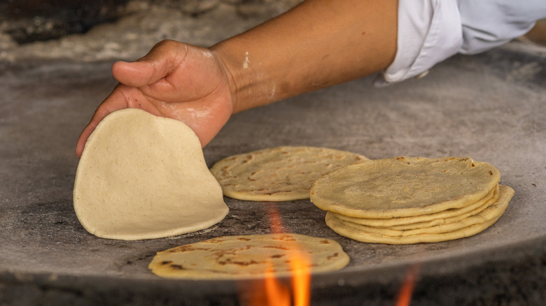 Making fresh tortillas on heated stone