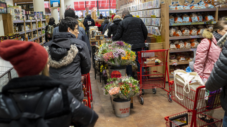 shoppers waiting in line at a Trader Joe's