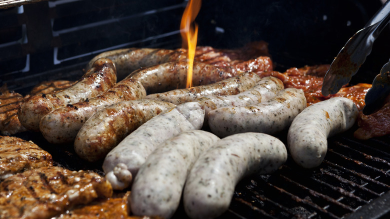 Sausages and meat on a charcoal grill