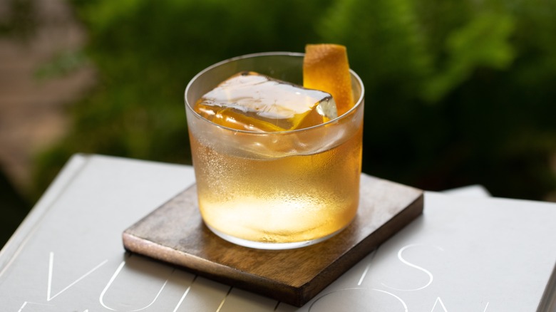 Ice block slowly melting in an Old Fashioned cocktail