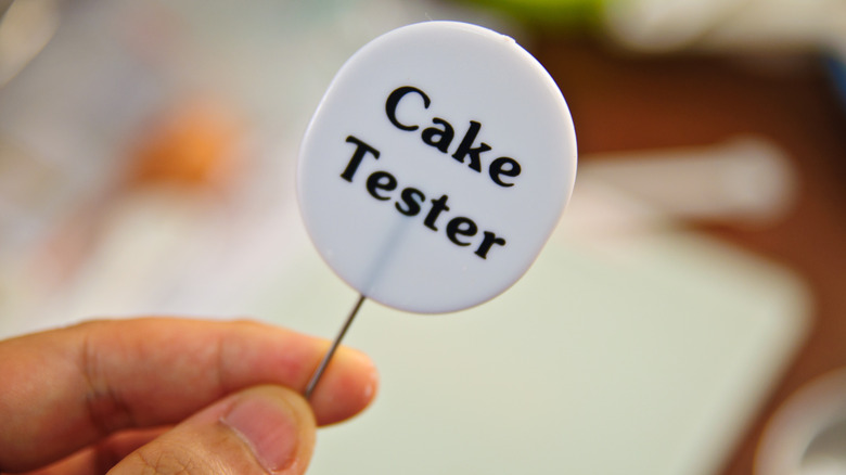 Cake tester in hand