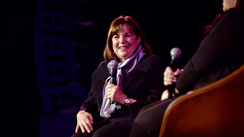 Ina Garten smiling while holding microphone.