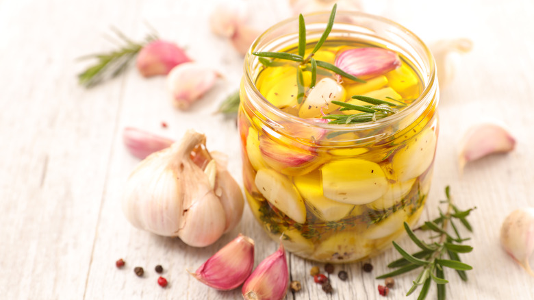 Garlic in olive oil in glass jar