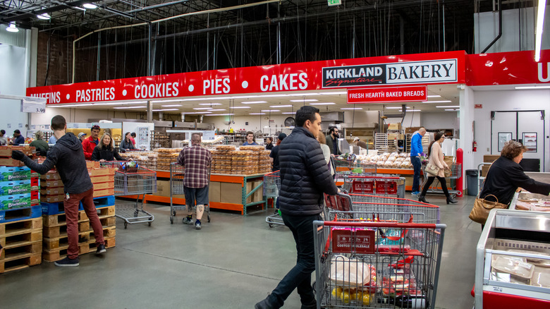 Customers inside Costco bakery section of store.