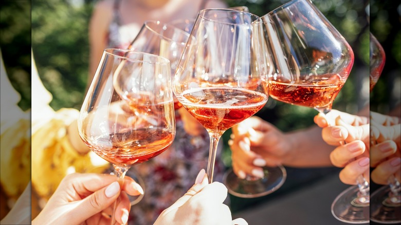 friends clinking glasses of rosé wine