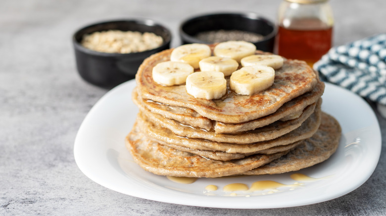 Oatmeal pancakes topped with banana slices.