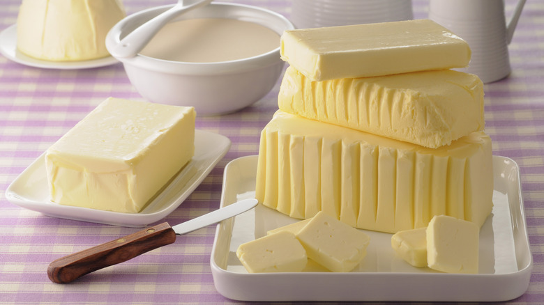 Various types of butter with a bowl of cream