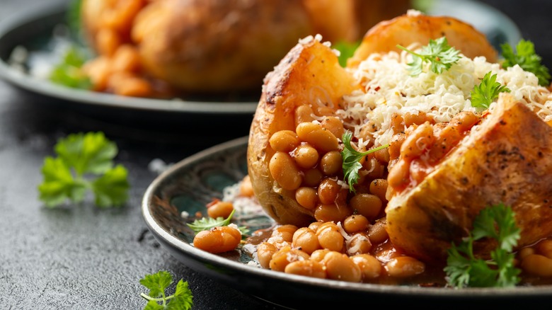 Traditional jacket potato with cheese, baked beans, and parsley