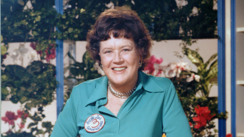 Julie Child smiling against floral background.